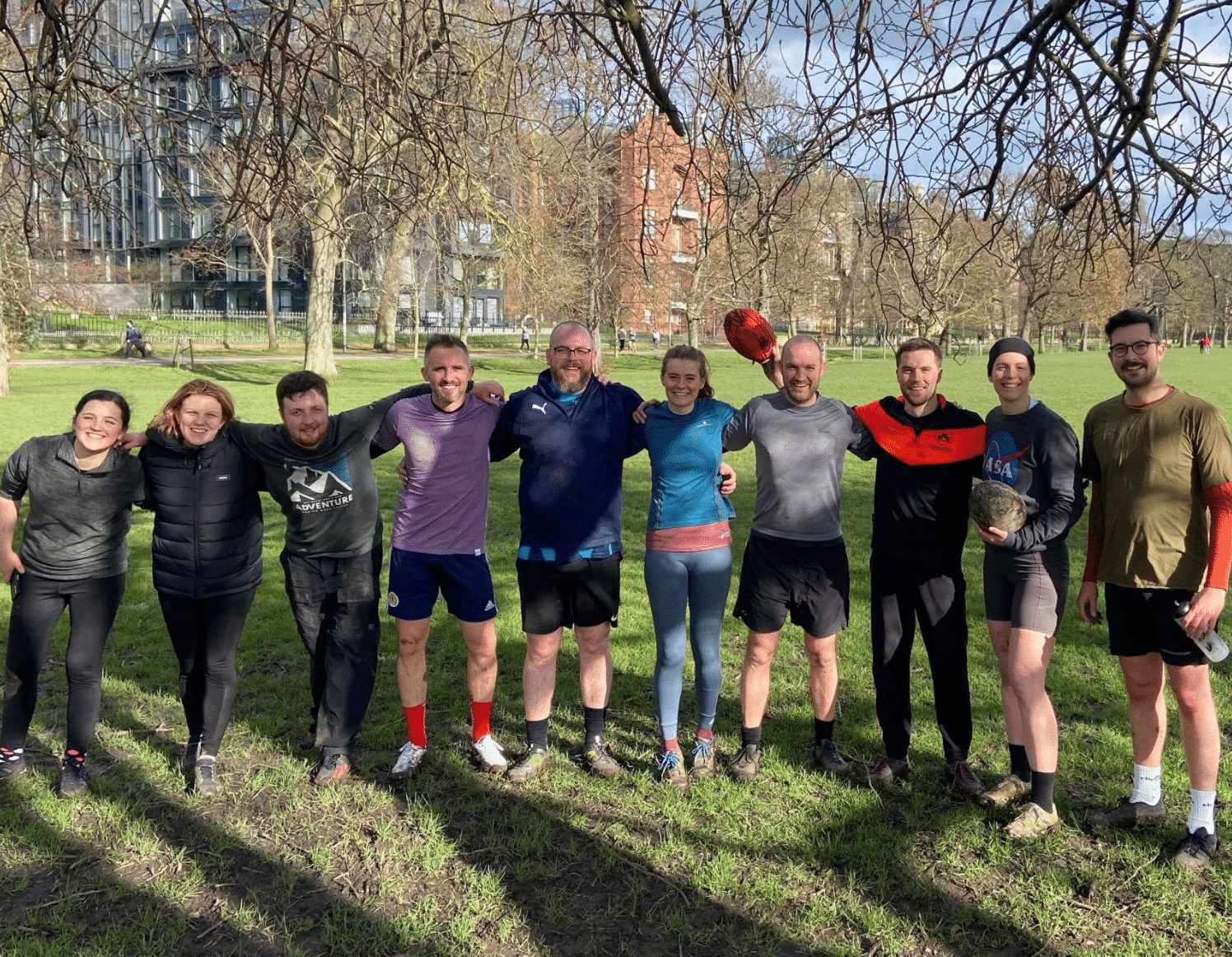 Dayshape touch rugby players pose for a photo in the park after training